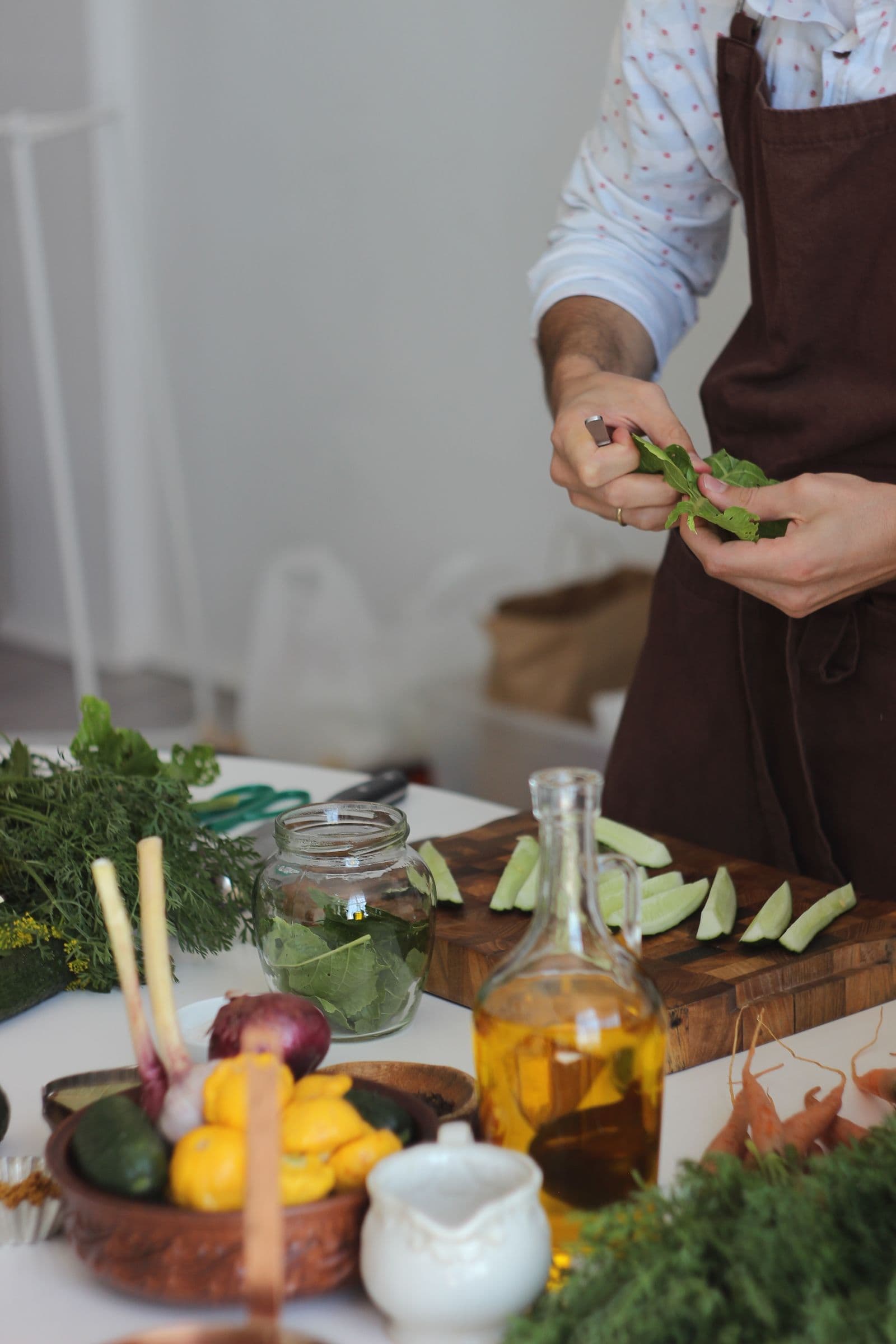 Fresh herbs and vegetables being prepared for a meal